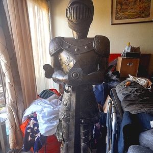 Standing on a pedestal  at 5'2 non wearable brass Suit of armor